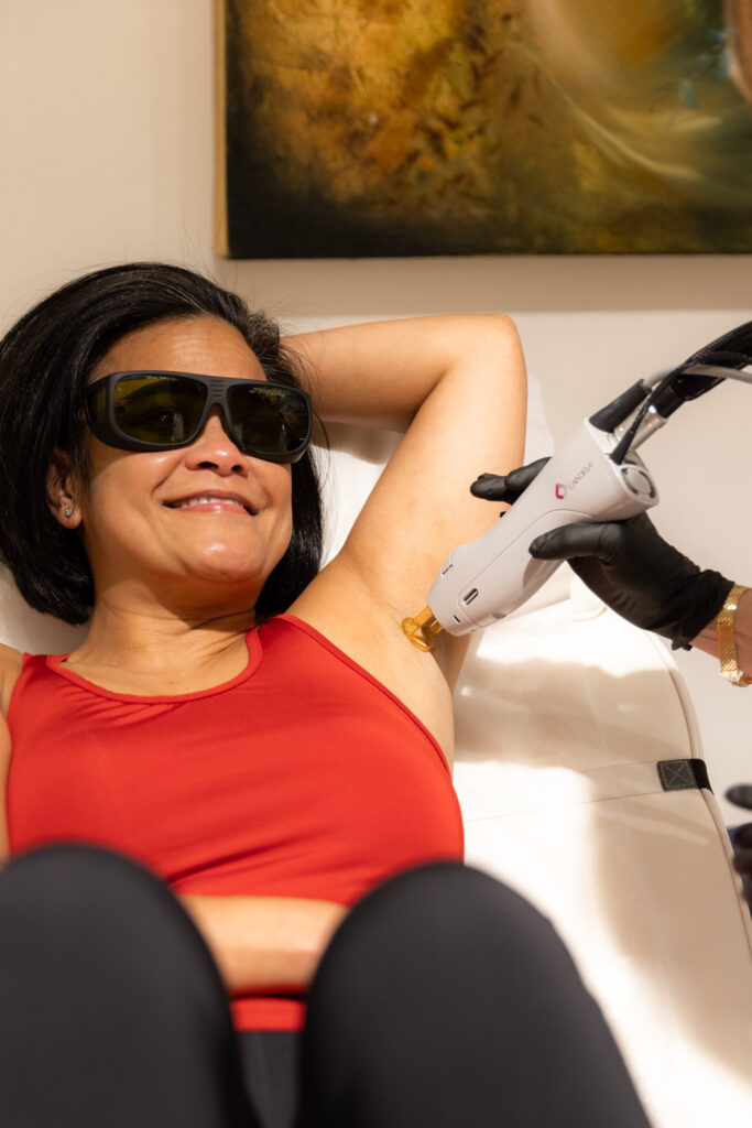 Smiling client receiving underarm laser hair removal treatment at Catara Med Spa in Algonquin, IL.