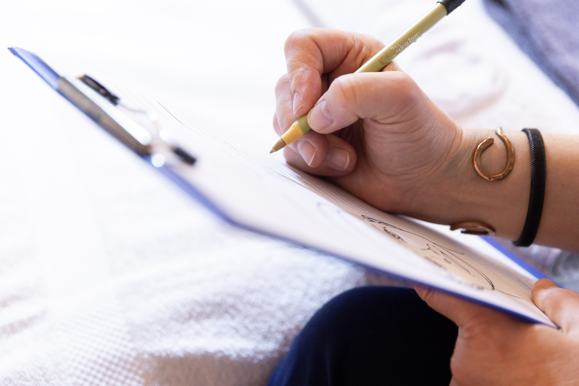 Client completing a laser vein removal consultation form at Catara Med Spa in Algonquin, IL