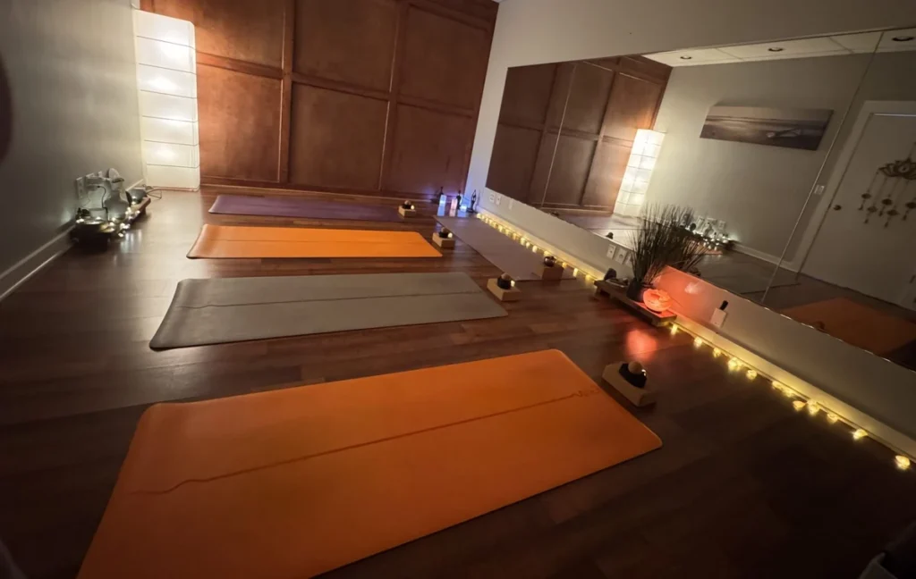 Yoga mats set up in a warm, softly lit studio at Mandala Yoga and Bodywork.
