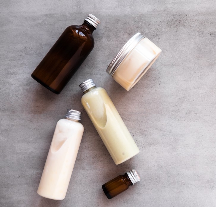 Flat lay of skin care bottles and jars used at Catara Med Spa in Algonquin, IL for custom skin routines.