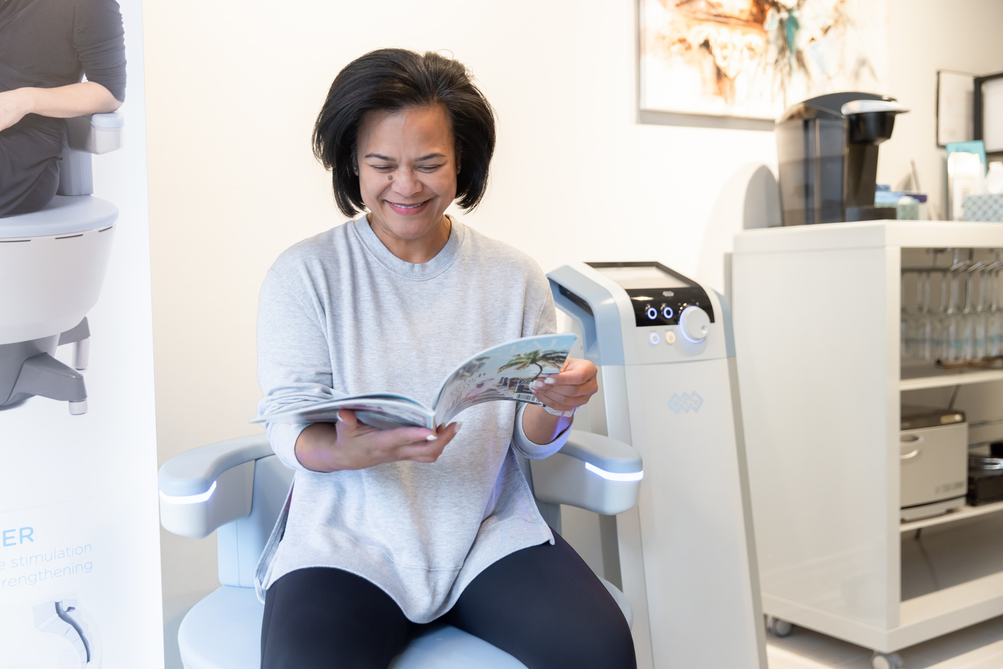 Client sitting comfortably in the Emsella chair during a pelvic floor therapy session at Catara Med Spa in Algonquin, IL.