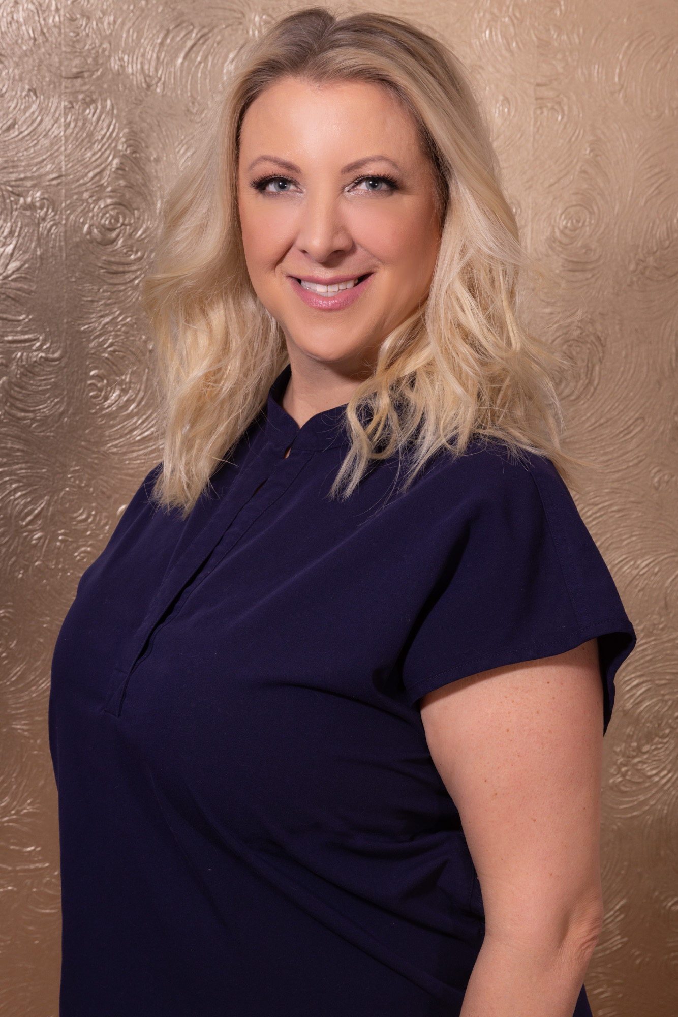 Karlene Stitle, advanced clinical aesthetician at Catara Med Spa in Algonquin, IL, in a navy top